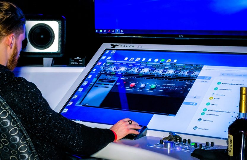 person in black long sleeve shirt playing game on computer